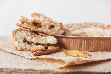 Homemade apple pie and cinnamon on vintage wooden background texture. Top view. Copy, empty space for text