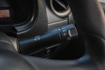 Switch off lights in a car. close-up Car integrated turning indicator with headlight switch toggle.