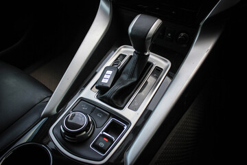 Obraz na płótnie Canvas automatic transmission shift selector in the car interior. Closeup a manual shift of modern car gear sifter.