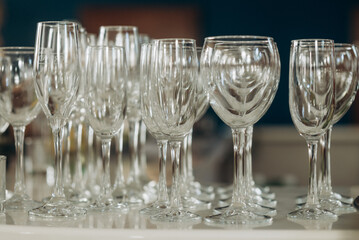 Stemware faceted glasses made of Czech glass with a Golden lines and patterns isolated on a white background.