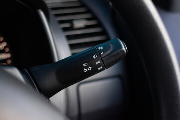 Switch off lights in a car. close-up Car integrated turning indicator with headlight switch toggle.