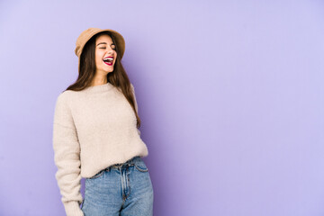 Young caucasian woman isolated on purple background relaxed and happy laughing, neck stretched showing teeth.