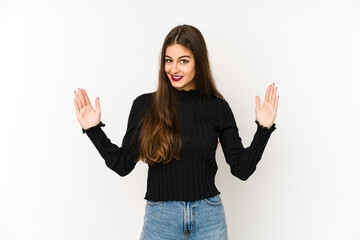 Young caucasian woman isolated on white background holding something little with forefingers, smiling and confident.