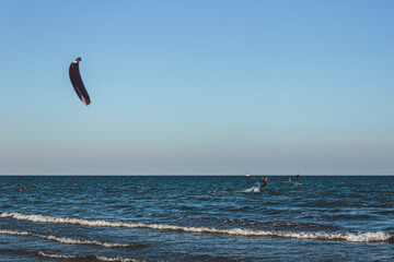Unidentified kitesurfer surfing the flat water of the Adriatic Sea in Rimini, Italy