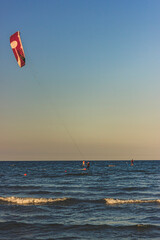 Unidentified kitesurfer surfing the flat water of the Adriatic Sea in Rimini, Italy