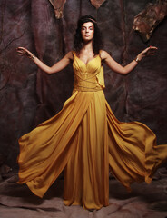 Fototapeta na wymiar brunette woman wearing yellow evening dress