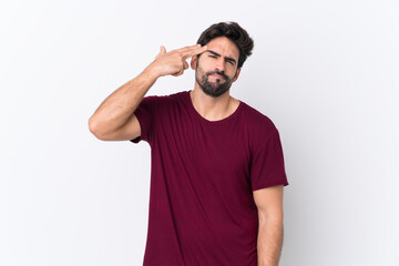 Fototapeta premium Young handsome man with beard over isolated white background with problems making suicide gesture
