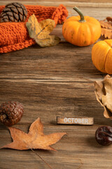 autumn template for October with dried leaves on wooden background