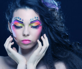 Beautiful lady with artistic make-up.