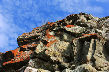 Stone granite rock on a background of blue sky