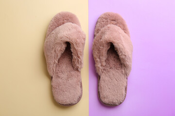 Pair of stylish soft slippers on color background, flat lay