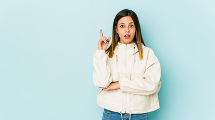 Young woman isolated on blue background having some great idea, concept of creativity.