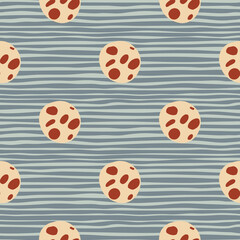Light orange cookies with red chocolate chips seamless pattern. Winter tasty dessert silhouettes on blue stripped background.