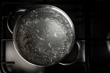 Boiling water in pan on stove.