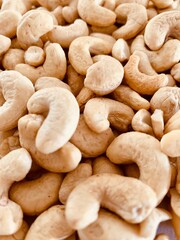 Nuts Cashews are scattered as a background on a table.