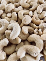 Nuts Cashews are scattered as a background on a table.