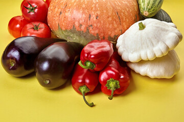 Fresh organic vegetables on a yellow background
