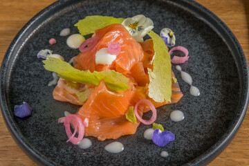 Smoked salmon with herb tuile and edible flowers
