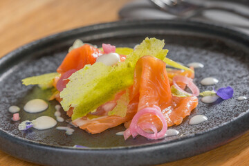 Smoked salmon with herb tuile and edible flowers