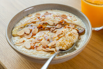 Breakfast porridge with flaked almonds and caramelised banana