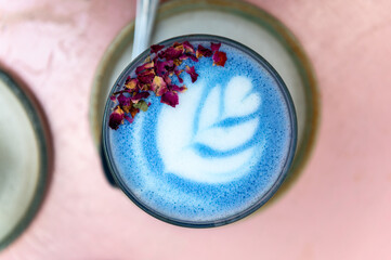 Glass of Super Latte with Art such as Butterfly Matcha from organic blue matcha and nut milk with...