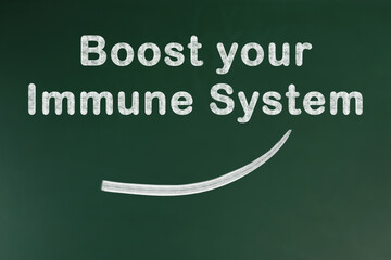 Obraz premium Phrase Boost Your Immune System on green chalkboard