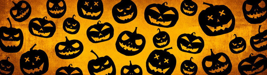 HALLOWEEN symbol background banner wide panoramic panorama template design -Top view Silhouette of scary carved luminous cartoon pumpkins isolated on dark orange yellow texture