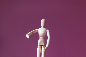 Wooden mannequin with its hand like it is holding something