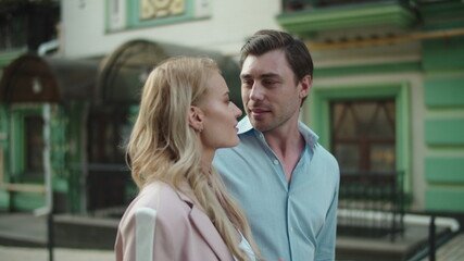 Lovely couple hugging at street. Business couple walking together outdoor
