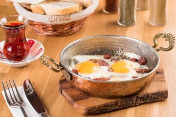 Traditional Turkish Breakfast - Fried Egg with Turkish sausage. Bread and Tea
