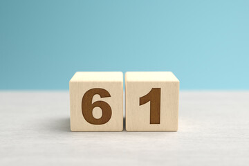 Wooden toy blocks forming the number 61.