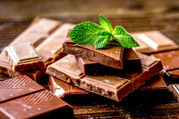 black and milk chocolate bars dark wooden table background