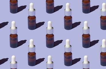 Seamless pattern of serums with collagen on purple background