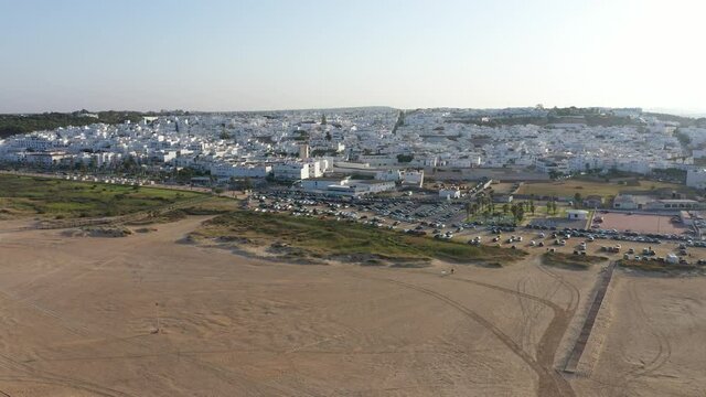 Paseo Maritimo of Conil and white town aerial panorama video