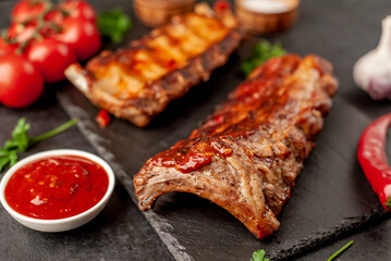 grilled pork ribs with spices on a stone background