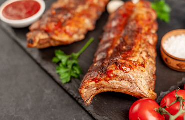  grilled pork ribs with spices on a stone background
