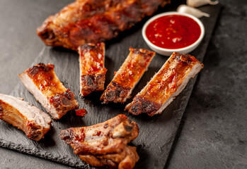grilled pork ribs with spices on a stone background