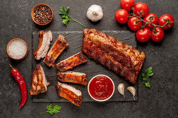 grilled pork ribs with spices on a stone background
