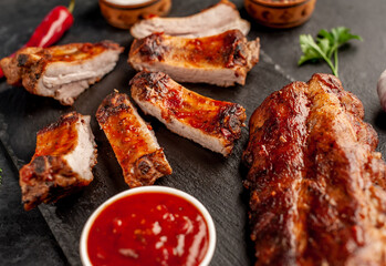 grilled pork ribs with spices on a stone background