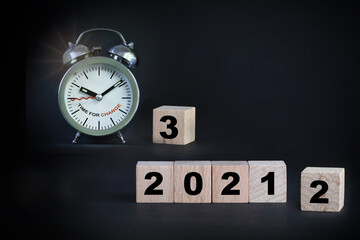 2021 to 2023 with alarm clock on black background, time for change concept and business success idea