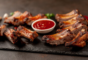 grilled pork ribs with spices on a stone background