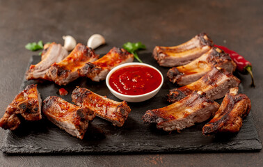 grilled pork ribs with spices on a stone background
