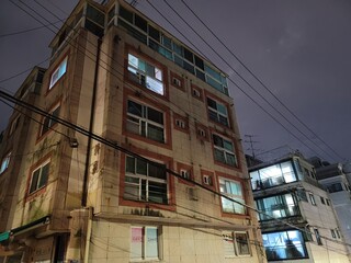 it is old building with electric wire in the sky (color)