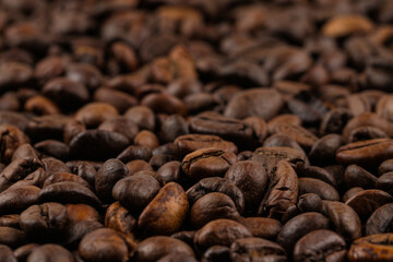 Dark texture with brown coffee beans. Cozy atmosphere.