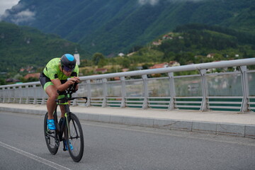 triathlon athlete riding a bike on morning training