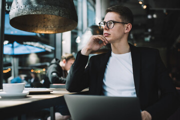 Focused businessman looking at window in cafe