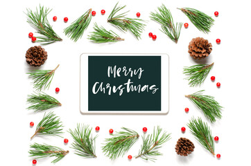 Christmas composition on a white background. Merry Christmas-handwritten inscription on the gadget screen. Flat lay.