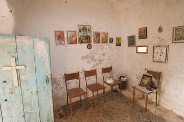 interior of small church with hanging green painted door on Kythira, Greece