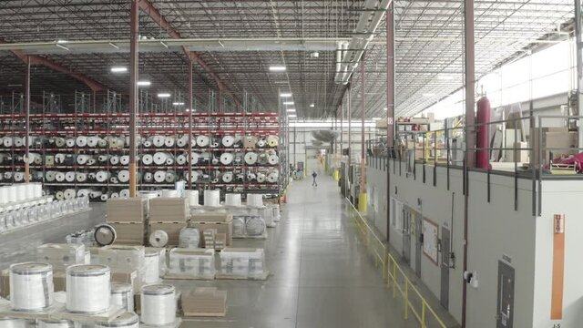 drone shot passing through a lane in a factory
