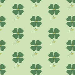 The seamless pattern with the abstract clover on the green background.